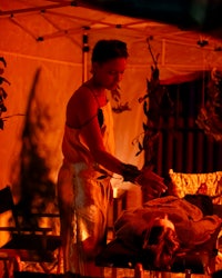 a woman is getting a massage in a tent